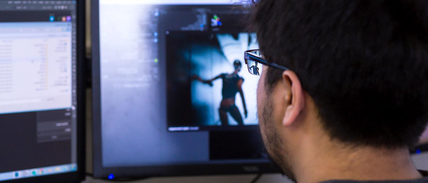 close up of a student at his computer working on a 3D animation project